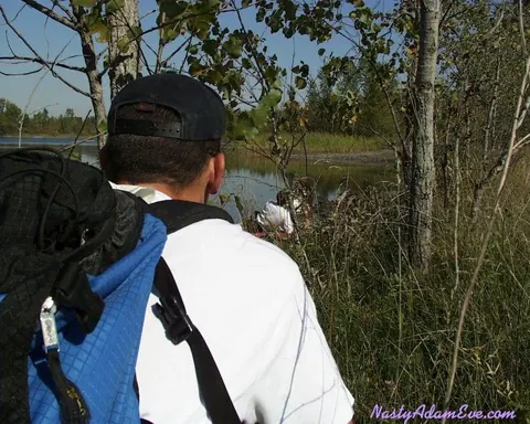 Woman in Shorts and Glasses Takes Two Men Outdoors – photo 2 of 15