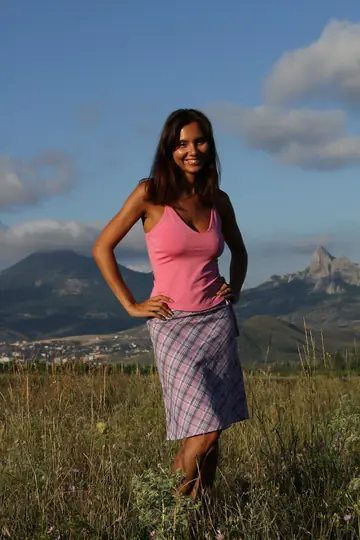 Busty Woman Strips and Spreads Outdoors with Mountains Behind