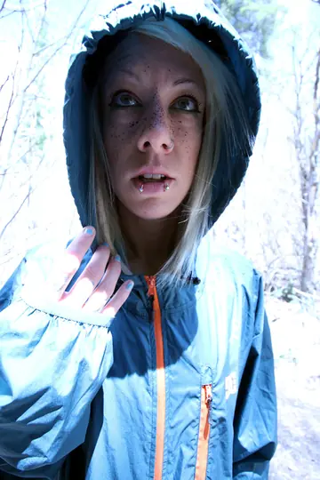 Slim Short-Haired Woman in Glasses and Bodysuit Spreads Outdoors