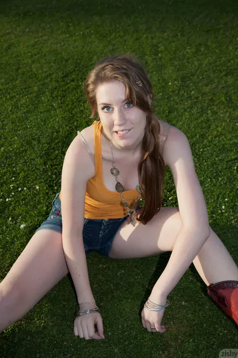 Athletic Brunette Shows Off Her Legs in Shorts and Boots Outdoors – photo 2 of 11