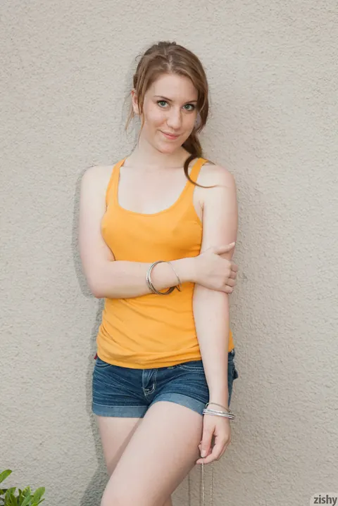Athletic Brunette Shows Off Her Legs in Shorts and Boots Outdoors – photo 11 of 11