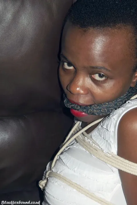 Ebony Brunette Spreads Her Legs While Bound and Cleave Gagged on Leather Sofa – photo 10 of 16