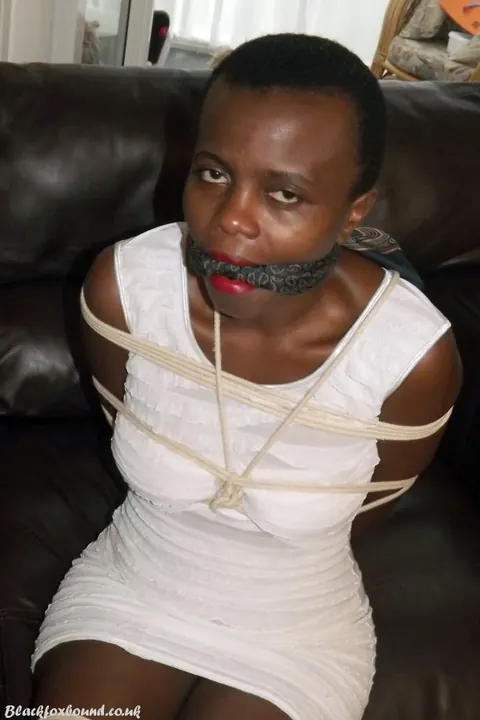 Ebony Brunette Spreads Her Legs While Bound and Cleave Gagged on Leather Sofa – photo 7 of 16