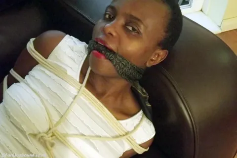 Ebony Brunette Spreads Her Legs While Bound and Cleave Gagged on Leather Sofa – photo 11 of 16