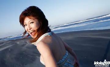 Japanese Brunette Reveals Her Big Tits on the Beach
