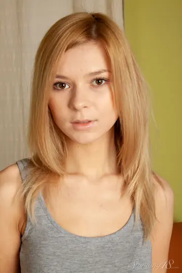 Blonde in Socks Shows Off Her Shaved Pussy on the Sofa