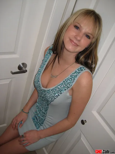 Blonde in a Dress and Heels Frees Big Tits and Squeezes Them – photo 8 of 12