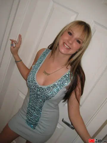 Blonde in a Dress and Heels Frees Big Tits and Squeezes Them