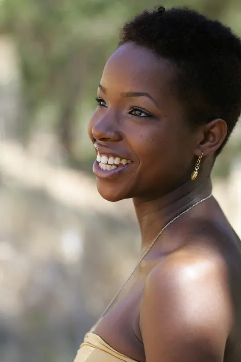 Ebony Woman with Short Hair Poses Fully Clothed – photo 7 of 20