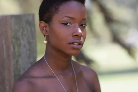 Ebony Woman with Short Hair Poses Fully Clothed – photo 4 of 20