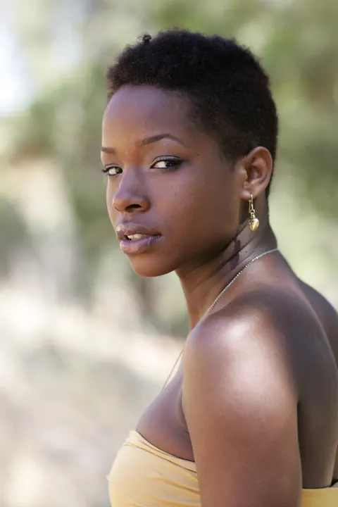 Ebony Woman with Short Hair Poses Fully Clothed – photo 14 of 20