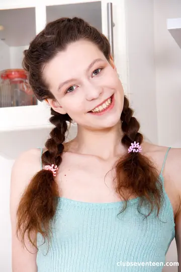 European Brunette in Pigtails Fingers Her Pussy on the Kitchen Chair