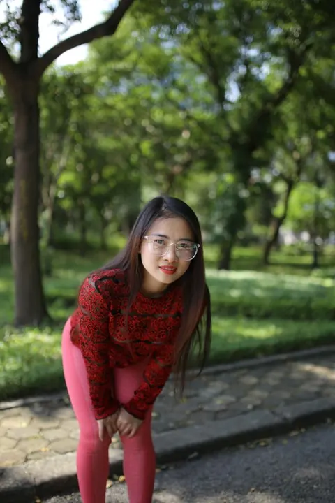 Asian Brunette in Yoga Pants and Glasses Poses Outdoors – photo 20 of 21