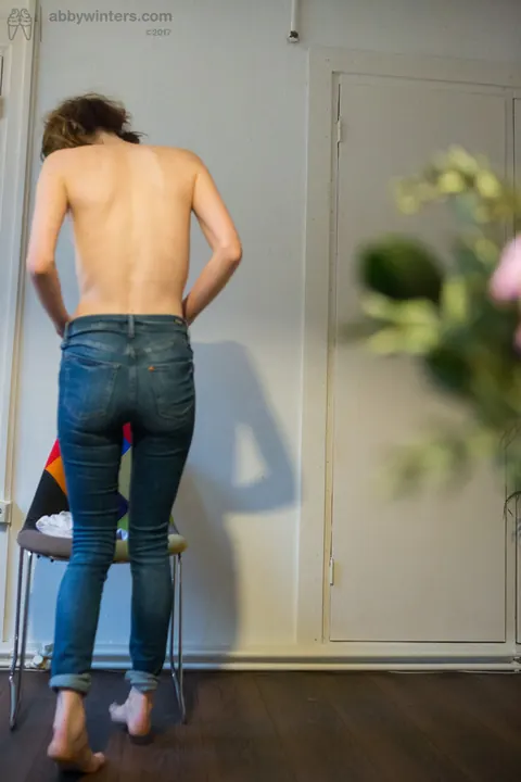 Emma Evins: Redhead in Glasses Pulls on Jeans and Panties After Nude Modeling – photo 11 of 16