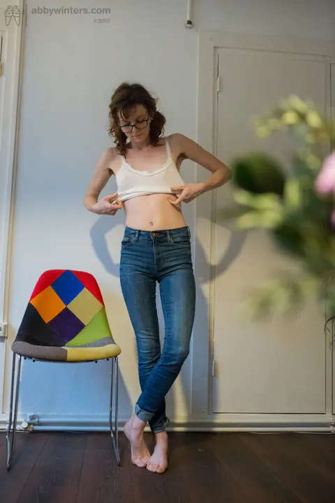 Emma Evins: Redhead in Glasses Pulls on Jeans and Panties After Nude Modeling – photo 15 of 16