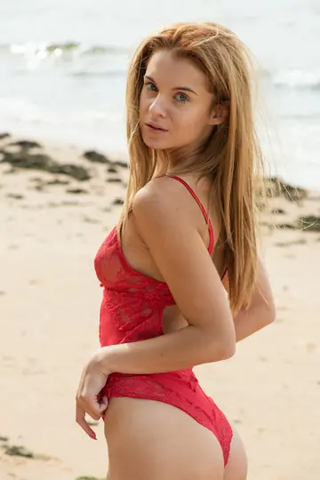 Slim Redhead with Big Tits Spreads in a Bodysuit on the Beach