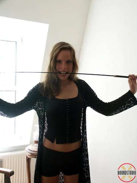 Blonde in Leather Shorts and High-Heeled Boots Wields Whip – photo 15 of 16