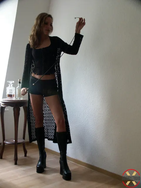 Blonde in Leather Shorts and High-Heeled Boots Wields Whip – photo 11 of 16