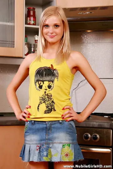 European Blonde Strips Out of Her Skirt and Panties in the Kitchen