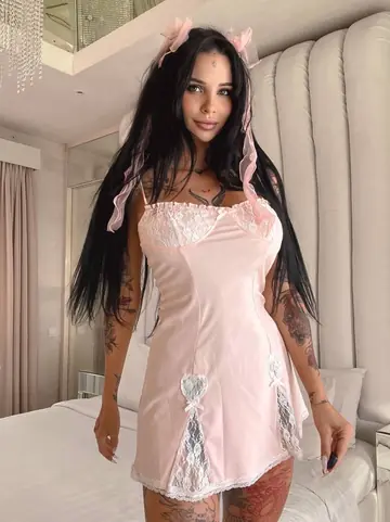 Busty Tattooed Brunette Spreads Her Legs in Heels on the Bed