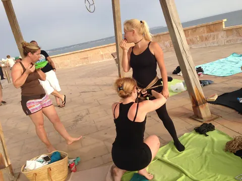 Blonde Hangs Suspended in Rope Bondage Outdoors Fully Clothed – photo 10 of 16