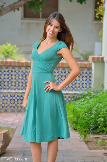 Slim Brunette in a Dress Poses in the Kitchen