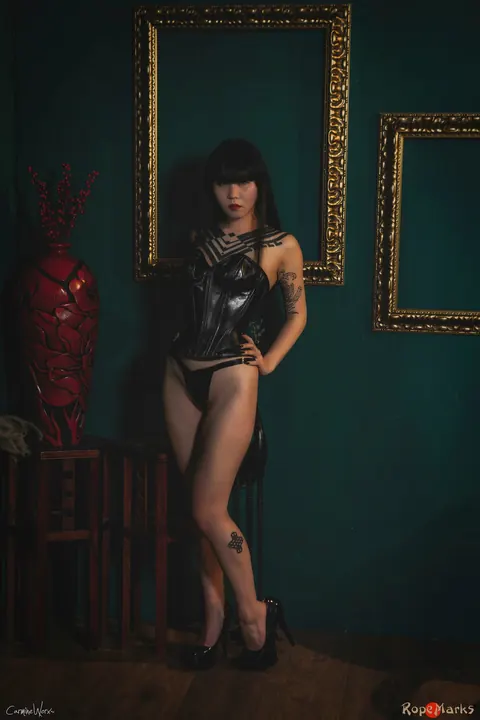 Thick Asian Brunette Flaunts Her Curves in a Leather Corset and Boots – photo 10 of 16