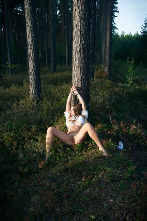 Blonde Lesbian in Bondage Plays with Hairy Pussy in the Forest – photo 20 of 21