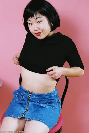 Short-Haired Asian Babe with Big Tits Strips Off Her Skirt