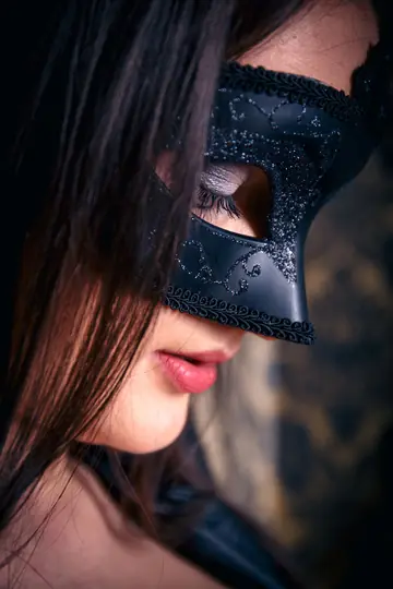 Busty Brunette Removes Mask and Poses Nude