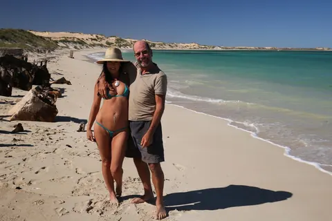 Brunette MILF with Big Tits Shows Off Her Bikini at the Beach – photo 18 of 18