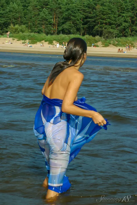 Woman Walks onto the Beach and Steps into the Surf – photo 9 of 16