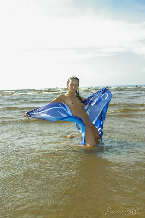Woman Walks onto the Beach and Steps into the Surf – photo 12 of 16
