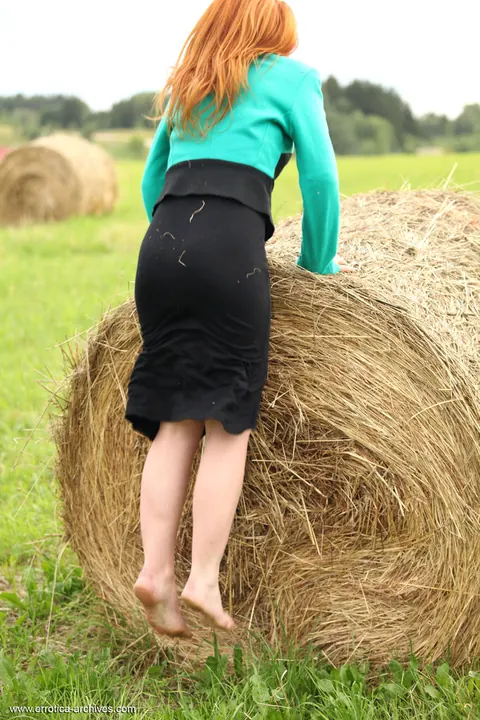 Woman Climbs Hay Bale and Spreads Outdoors – photo 3 of 16