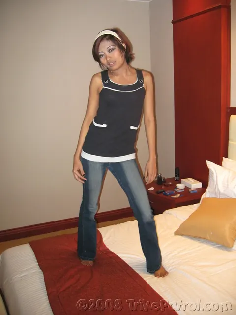 Asian Brunette Strips Out of Her Jeans on the Bed – photo 1 of 21