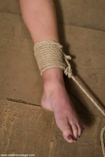 Tall Brunette Bound in Bondage Restraints While Nude