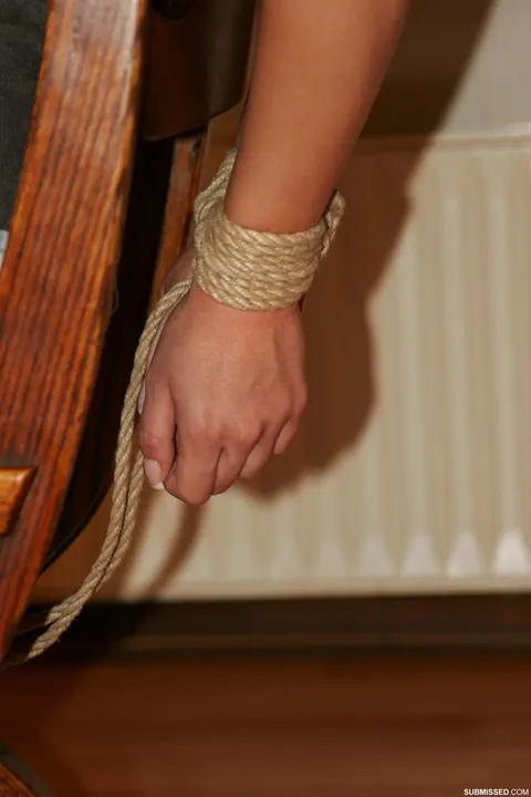 Brunette in Jeans and Heels Tests Restraints While Tied to a Chair – photo 4 of 20
