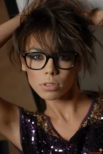 European Woman in a Skirt and Glasses Strips Nude and Poses