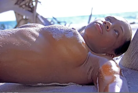 Thick Ebony Babe Oils Her Big Tits on the Beach – photo 4 of 21