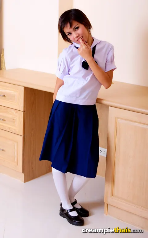 Thai Brunette Peels Off Her Uniform and Rubs Her Trimmed Pussy – photo 1 of 20