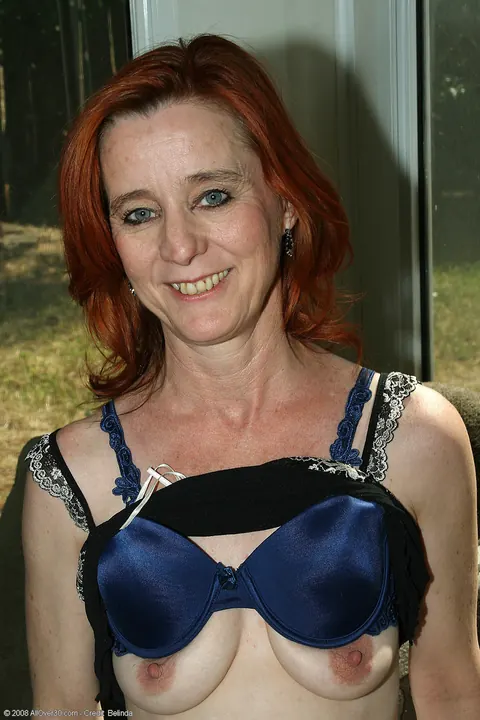 Redhead in a Skirt Pulls Panties Aside and Spreads Her Shaved Pussy – photo 7 of 20