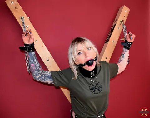 Blonde in Shorts and Socks Chained to a Cross in Bondage – photo 4 of 16