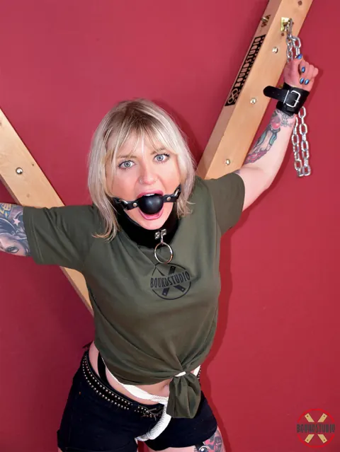 Blonde in Shorts and Socks Chained to a Cross in Bondage – photo 14 of 16