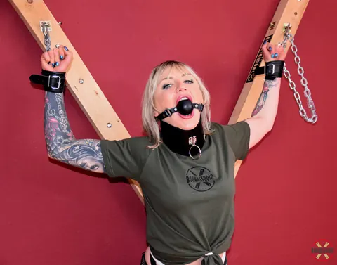 Blonde in Shorts and Socks Chained to a Cross in Bondage – photo 10 of 16