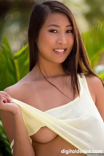 Asian Brunette Lifts Her Arms and Bares Her Natural Tits