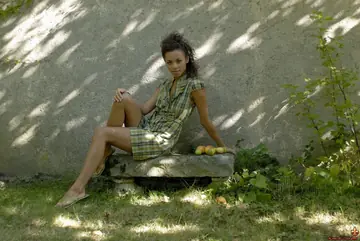 European Woman Strips Out of Her Skirt Against the Garden Wall