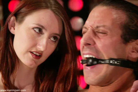 Kendra James: Redhead in a Leather Dress Gives Bound Man a Handjob – photo 4 of 14