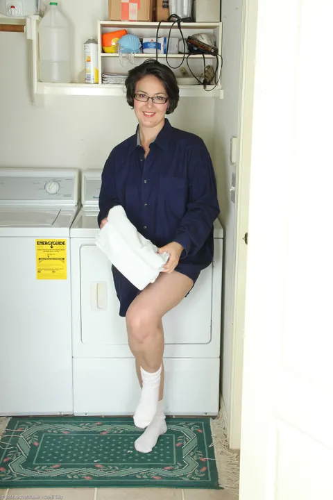 Carlita Johnson: Tattooed Brunette MILF Undresses in Laundry Room Keeping Glasses On – photo 4 of 21