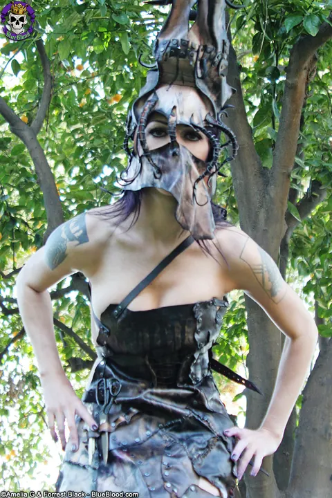 Kellie Laplegua: Slim Tattooed Brunette Strips Out of Her Leather Costume Under a Tree – photo 1 of 15