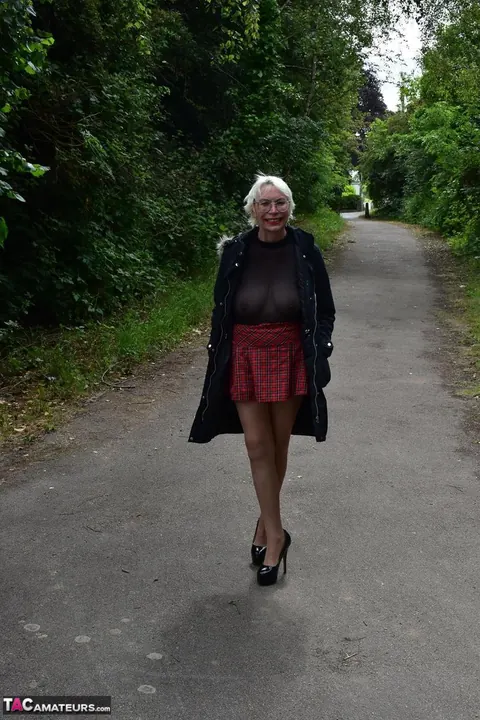 Mature Blonde in a Skirt and Heels Spreads Outdoors – photo 1 of 16